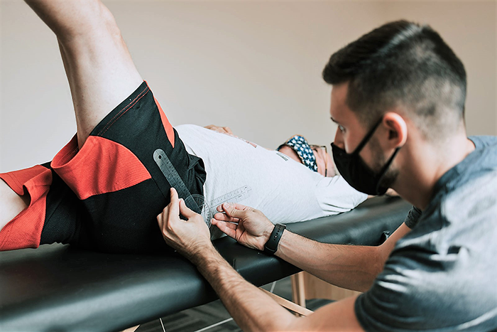 Fitness coach assessing for range of motion