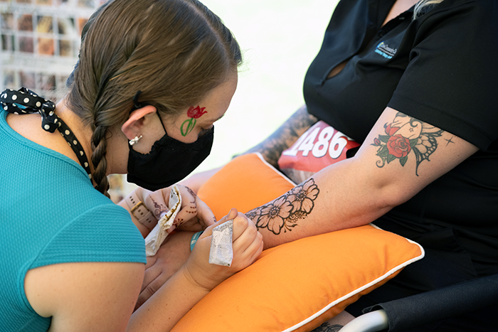 A woman getting henna art at a walk to benefit Parkinson’s disease in Fresno
