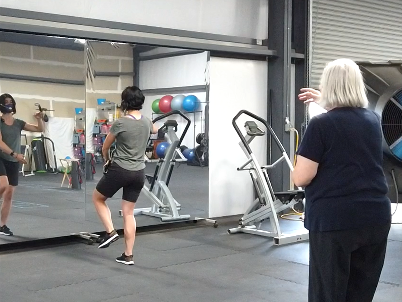 Coach leading tai chi class to improve balance